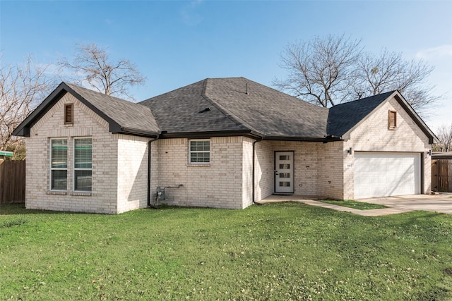 view of front of home with a garage and a front lawn