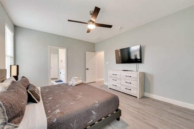 bedroom featuring ceiling fan, ensuite bathroom, and light hardwood / wood-style floors