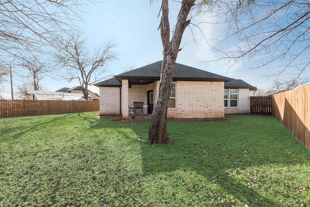 back of house with a lawn