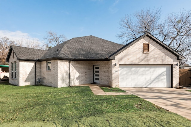 view of front of property with a garage and a front yard