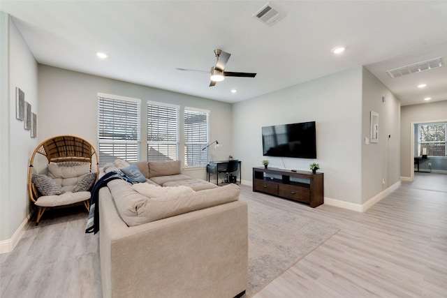 living room with ceiling fan and light hardwood / wood-style floors