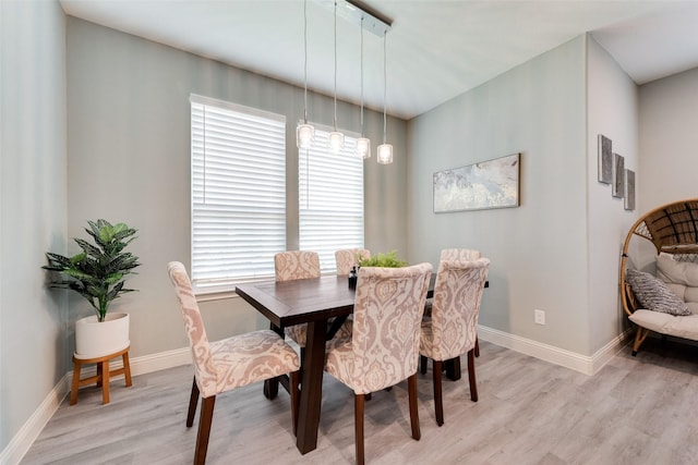 dining space with plenty of natural light and light hardwood / wood-style flooring