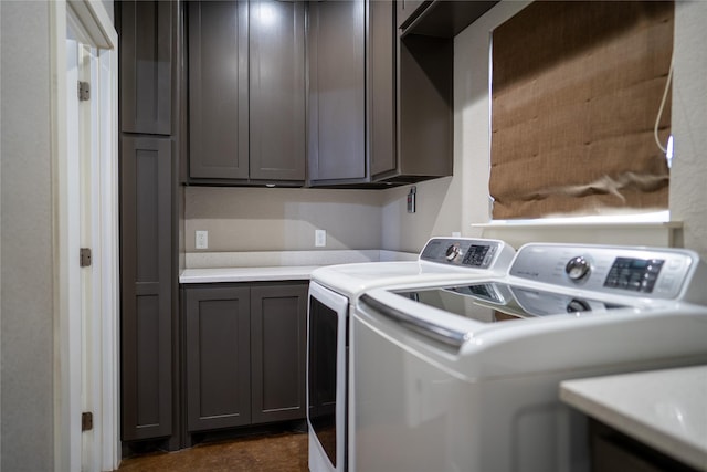 laundry area with washer and dryer and cabinets