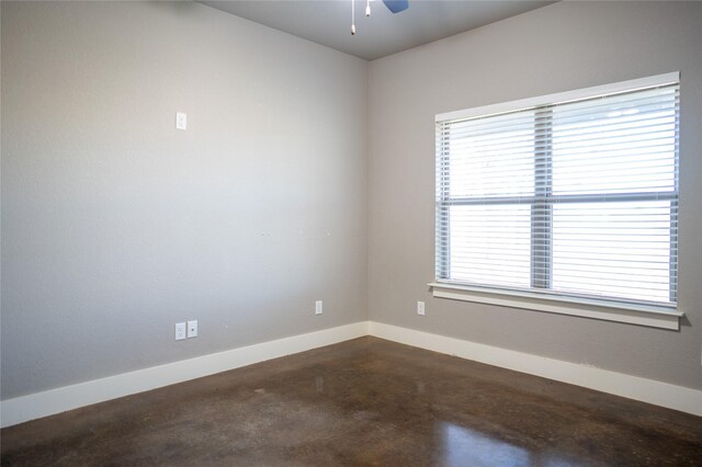 unfurnished room with concrete floors and ceiling fan