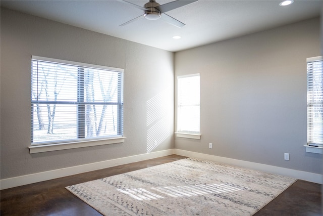 interior space featuring ceiling fan and multiple windows