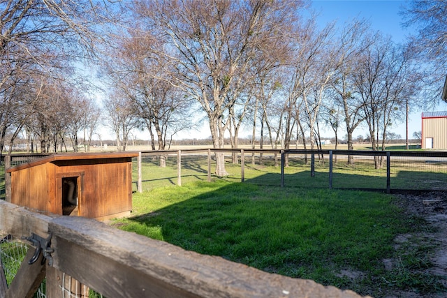 view of yard with a storage unit and a rural view