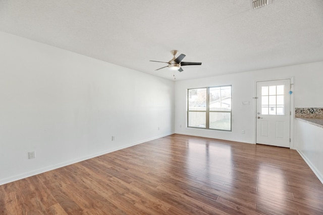 unfurnished living room with wood-type flooring and ceiling fan