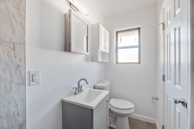 bathroom with vanity, tile patterned floors, and toilet