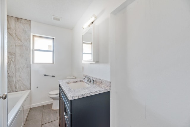 bathroom featuring vanity, tile patterned floors, and toilet