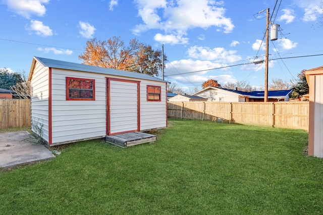 view of outbuilding featuring a lawn