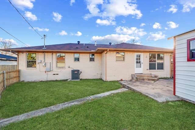 back of house with central AC unit, a yard, and a patio