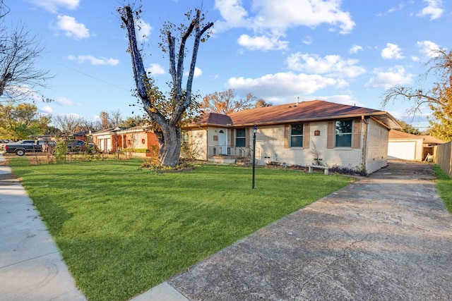 ranch-style house featuring a garage, an outdoor structure, and a front lawn