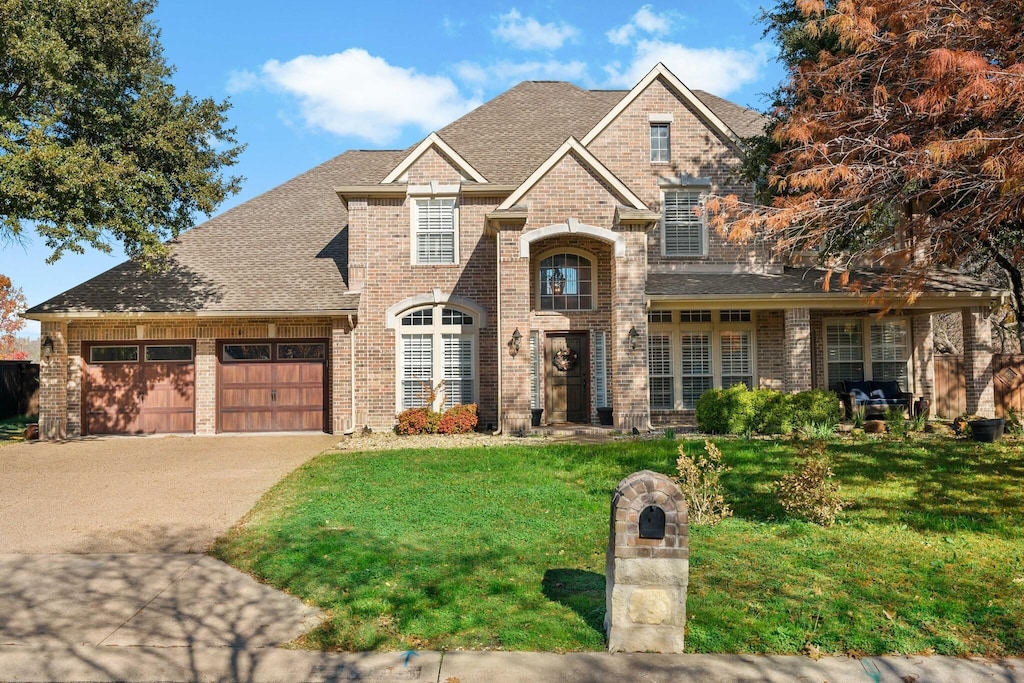 view of front facade with a garage and a front lawn