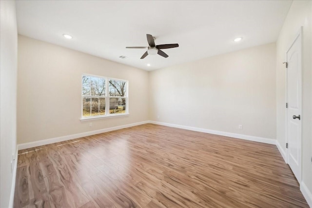 empty room featuring ceiling fan and light wood-type flooring