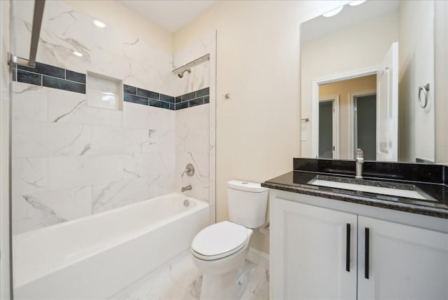 full bathroom with toilet, vanity, and tiled shower / bath