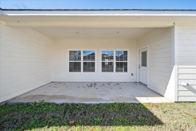 property entrance featuring a patio area