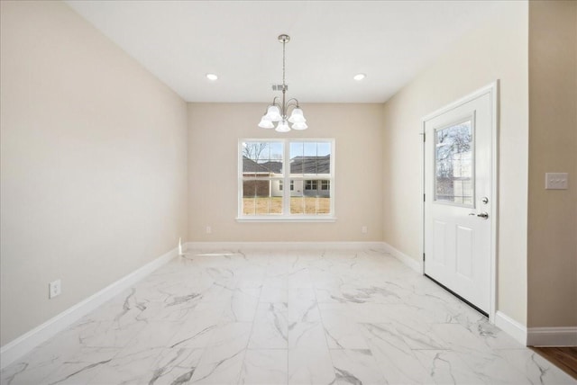 unfurnished dining area featuring a chandelier