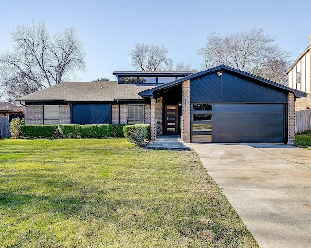 view of front of home with a garage and a front lawn