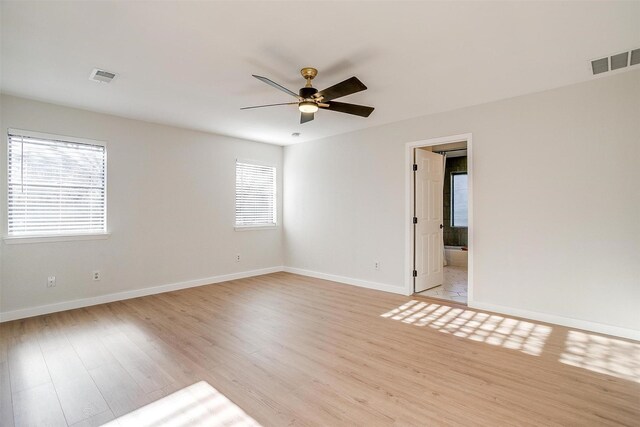 empty room with ceiling fan and light hardwood / wood-style floors