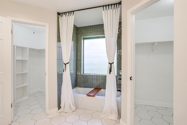 bathroom featuring tile patterned flooring and shower / bathtub combination with curtain