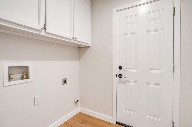 laundry area featuring electric dryer hookup, cabinets, light wood-type flooring, and washer hookup