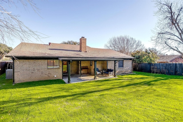 rear view of property featuring a patio and a lawn