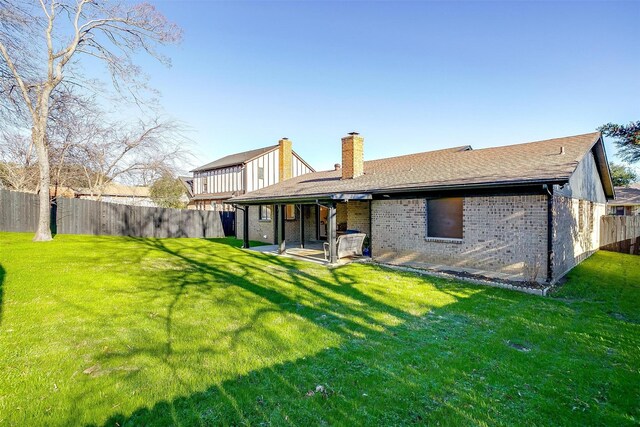 back of property featuring a lawn and a patio