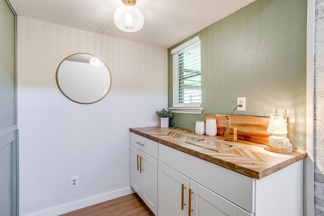 bathroom featuring hardwood / wood-style flooring and vanity