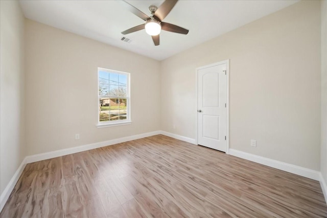 spare room featuring light wood-type flooring and ceiling fan