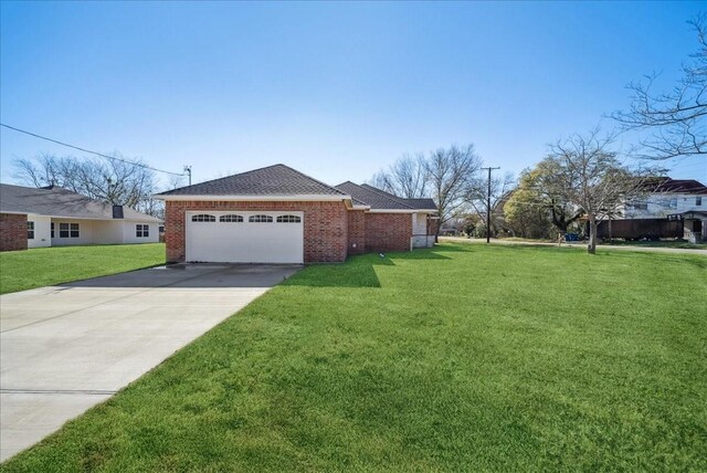 view of side of home with a lawn and a garage