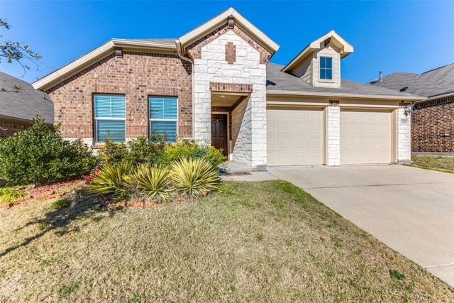 2408 Buchanan Ln, Forney, TX 75126 - view of front of home with an attached garage, concrete driveway, a front yard, brick siding, and stone siding