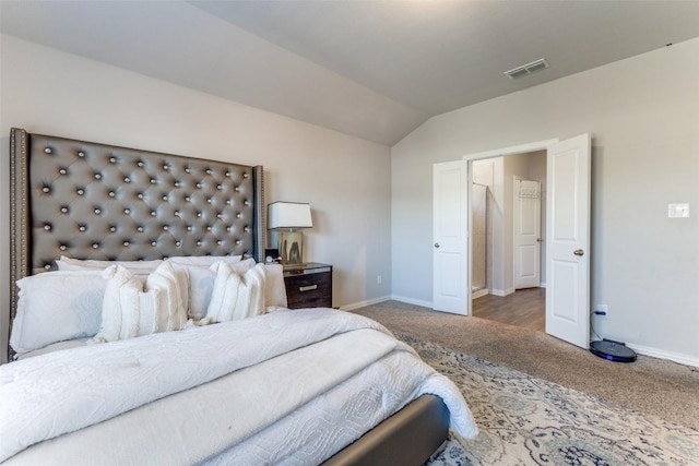 bedroom featuring lofted ceiling and carpet floors