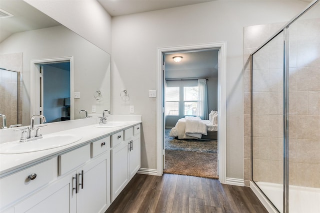 bathroom with a shower with door, wood-type flooring, and vanity