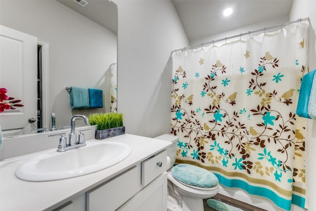 bathroom with vanity, a shower with shower curtain, and toilet