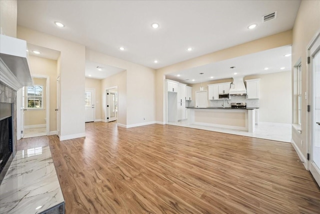 unfurnished living room with light hardwood / wood-style floors