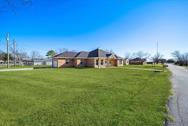 view of side of property with a lawn