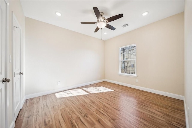 spare room featuring hardwood / wood-style flooring and ceiling fan