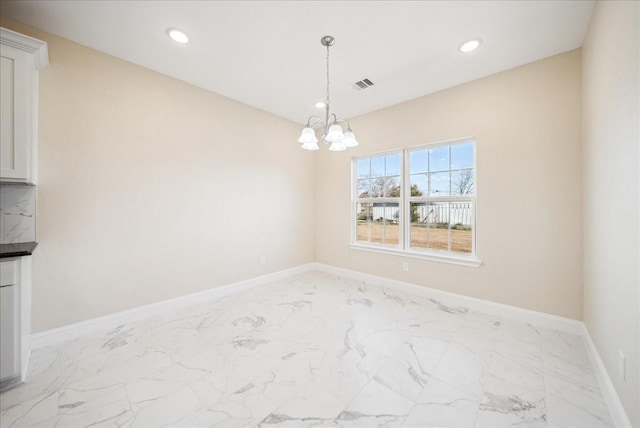 unfurnished dining area with a notable chandelier