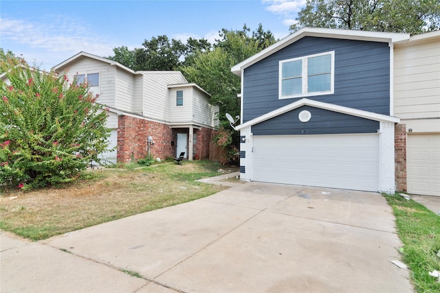 view of property featuring a garage and a front yard