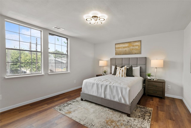 bedroom with dark hardwood / wood-style flooring