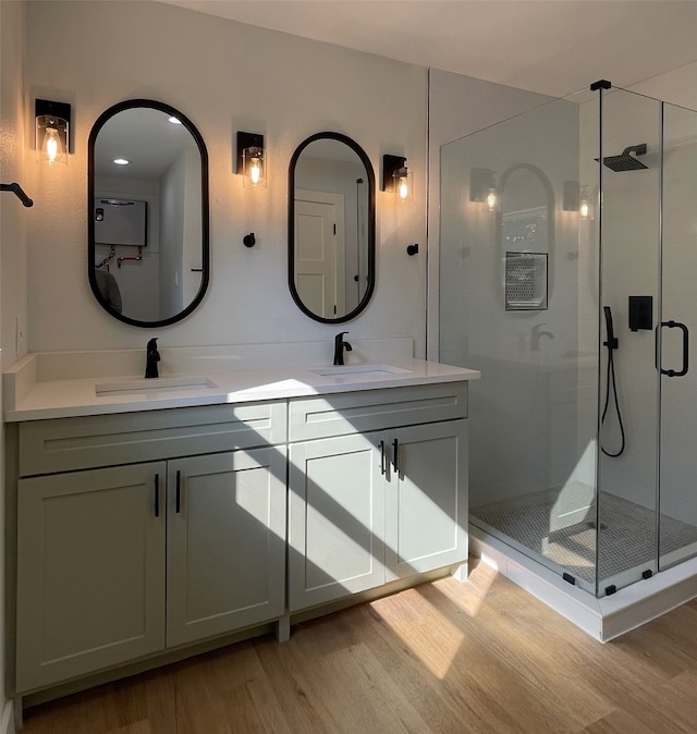 bathroom with vanity, an enclosed shower, and hardwood / wood-style floors