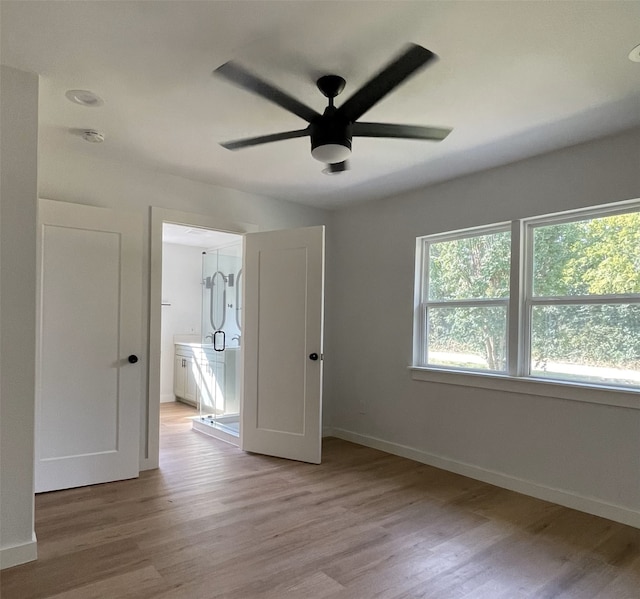 unfurnished bedroom with ceiling fan and light hardwood / wood-style floors