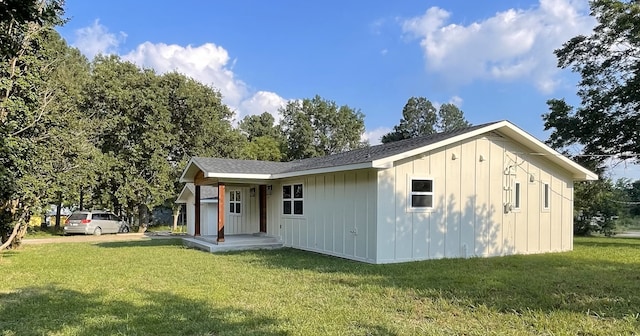 back of house with a lawn