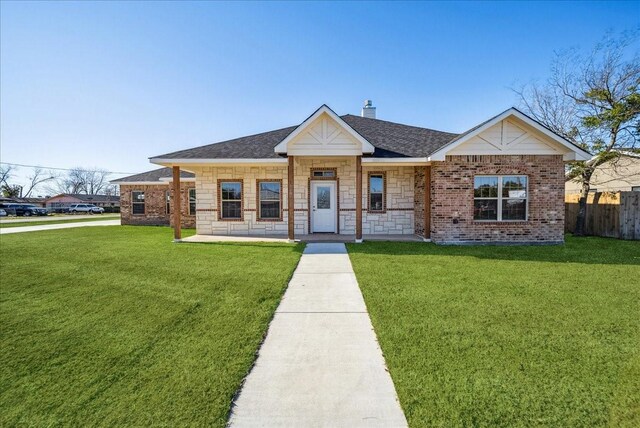 ranch-style home featuring a front lawn and a garage