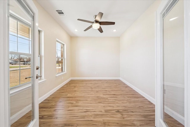 unfurnished room featuring ceiling fan and light hardwood / wood-style floors