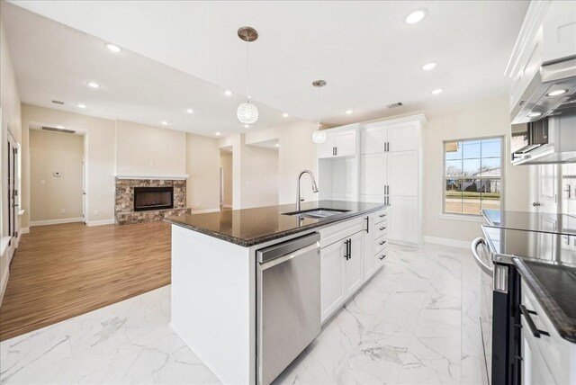 kitchen with white cabinetry, sink, an island with sink, and appliances with stainless steel finishes