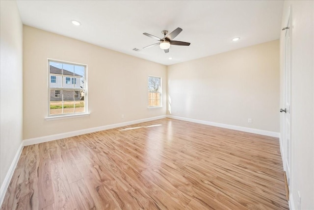 spare room featuring ceiling fan and light hardwood / wood-style flooring