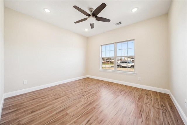 empty room with light wood-type flooring and ceiling fan