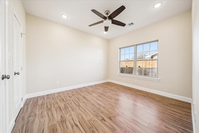 spare room with ceiling fan and light wood-type flooring