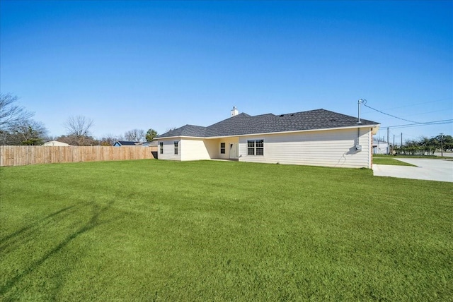 rear view of property featuring a yard